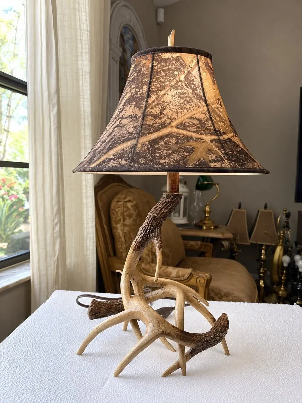 rustic table lamp featuring a base made of camo-patterned fabric lampshade